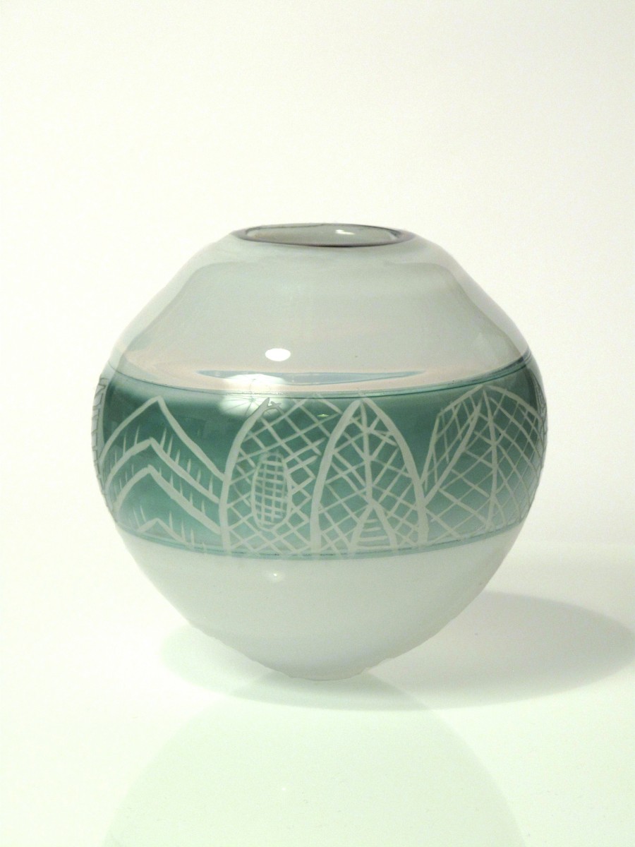 White and steel grey blown glass vessel with engraved pattern of architectural details