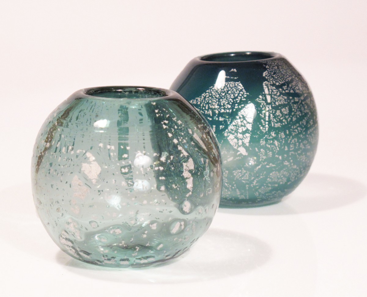 Two round glass candle holders in green with silver leaf