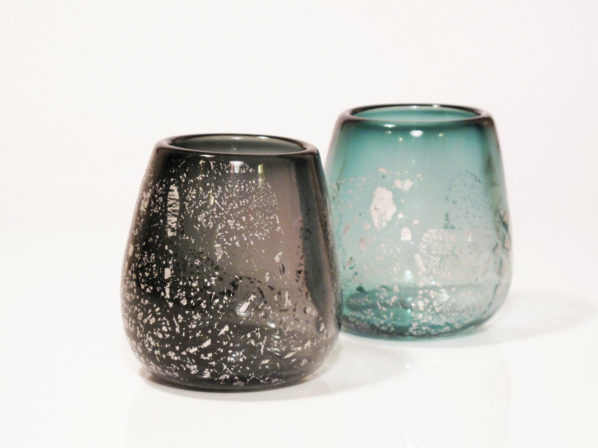Two glass candle holders in grey and steel with silver leaf