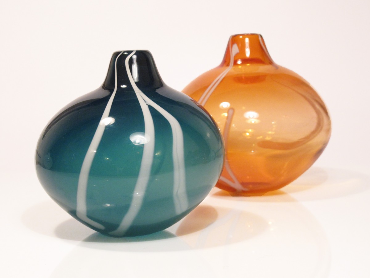 Two glass vases, one sea green and one apricot with white stripe pattern