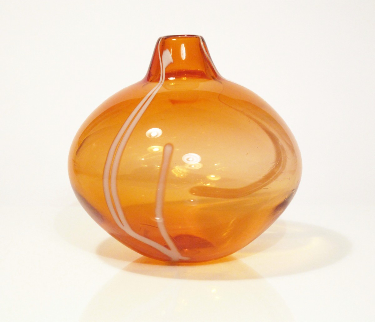 Apricot coloured blown glass vase with white stripes