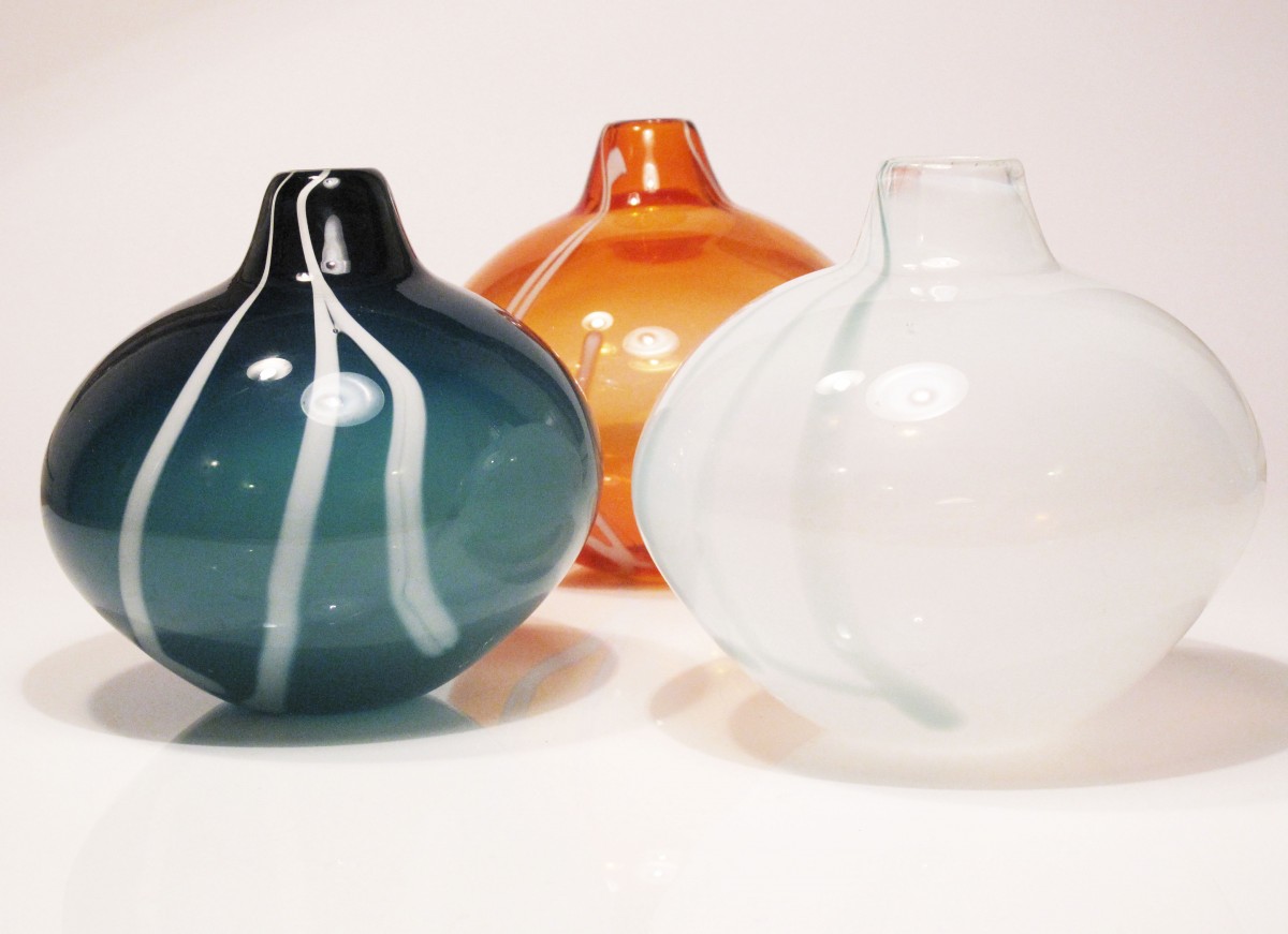 Three glass vases in sea green, apricot and white with stripe decoration
