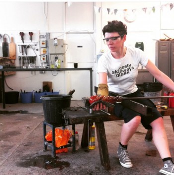 A woman blowing glass